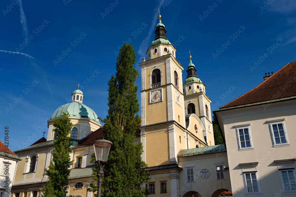Clock and Bell towers with copper dome of St. Nicholas Catholic church Ljubljana Cathedral from Pogacar Square Ljubljana Slovenia
