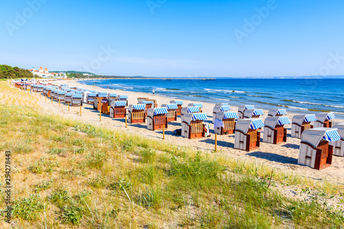 Wicker chairs on sandy beach and bay in coastal holiday resort of Binz, Rugen island, Baltic Sea, Germany