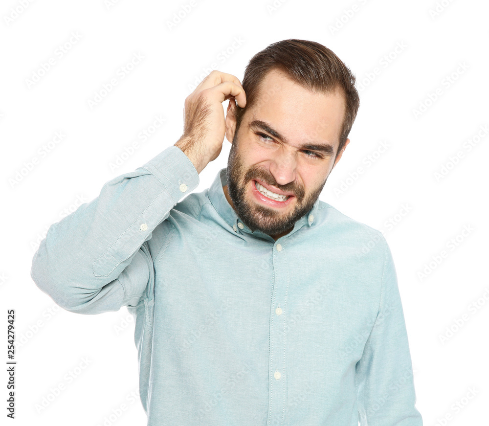 Young man scratching head on white background. Annoying itch Young man scratching head on white background. Annoying itch