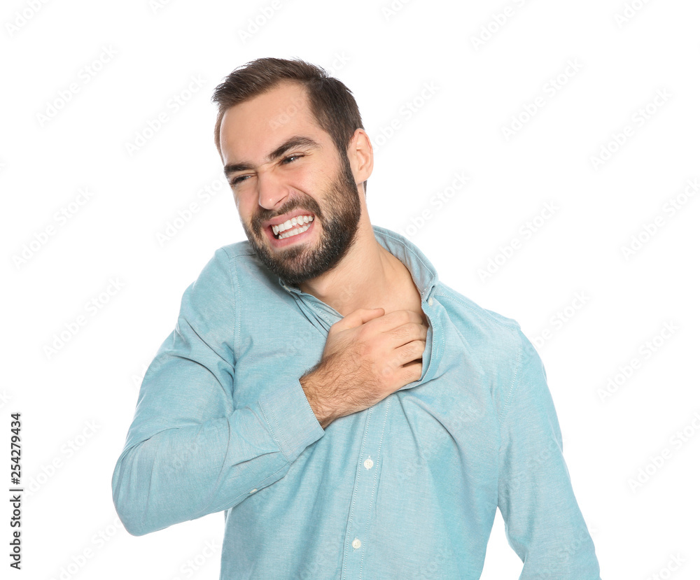 Young man scratching skin on white background. Annoying itch Young man scratching skin on white background. Annoying itch