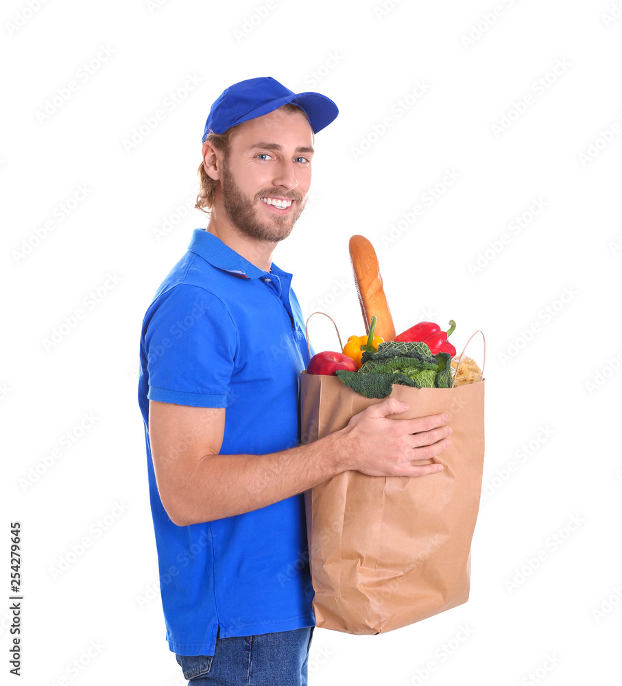 Delivery man holding paper bag with food products on white background Delivery man holding paper bag with food products on white background