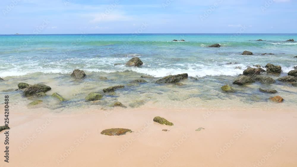 Medium wide video of waves hitting the shore at a rocky beach Medium wide video of waves hitting the shore at a rocky beach