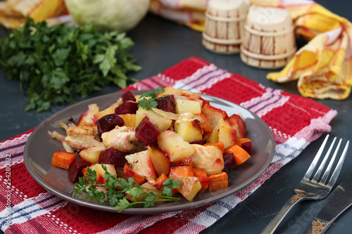 Baked chicken with vegetables: beets, carrots, cabbage and potatoes