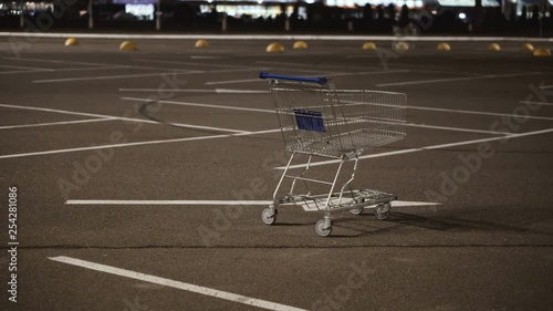 Shopping cart stands in the car parking