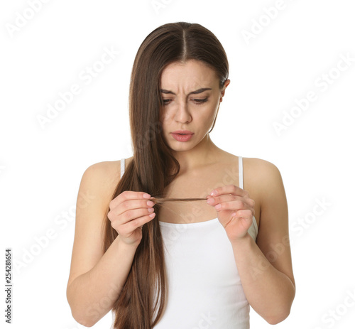 Emotional woman with damaged hair on white background