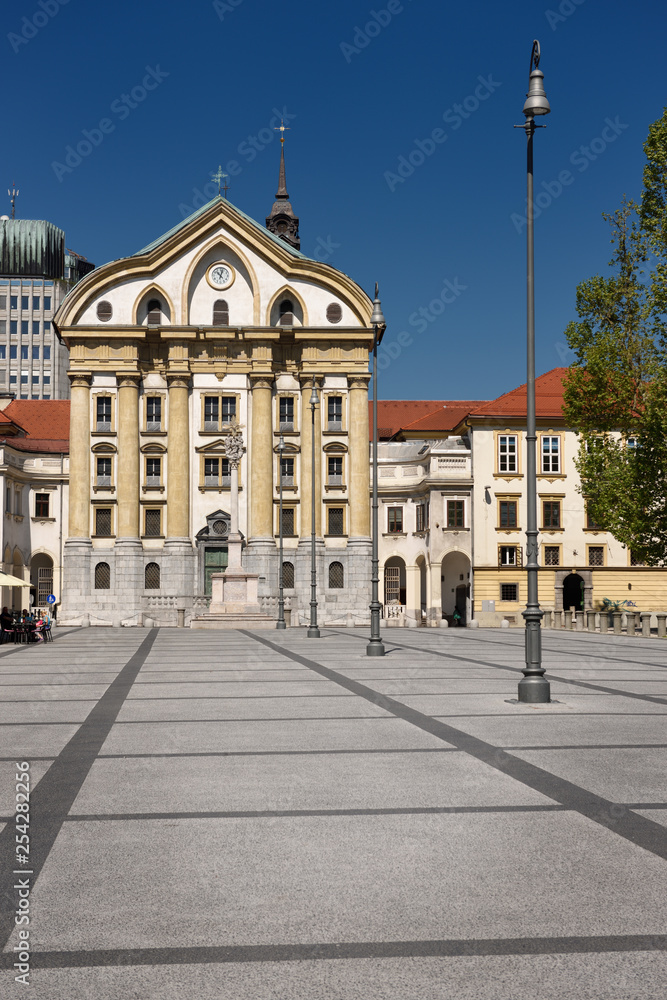 Blue sky at Congress Square with Ursuline Church of the Holy Trinity with marble statues of the Holy Trinity column in Ljubljana Slovenia