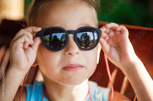 Portrait of a beautiful baby boy in sunglasses