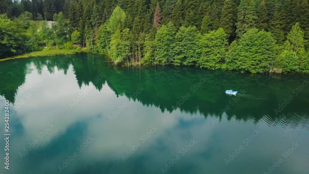 hd aerial spinning drone shot, over azure lake, reflecting trees and sky, in Savsat Karagol Artvin Turkey hd aerial spinning drone shot, over azure lake, reflecting trees and sky, in Savsat Karagol Artvin Turkey