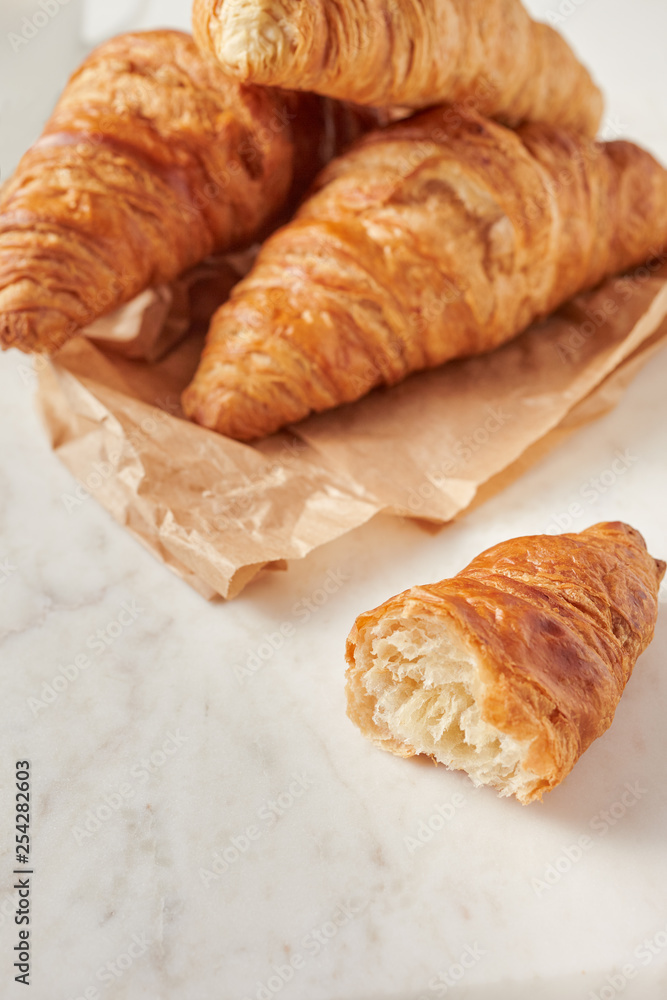 Croissants on the parchment paper, on the marbel board Croissants on the parchment paper, on the marbel board