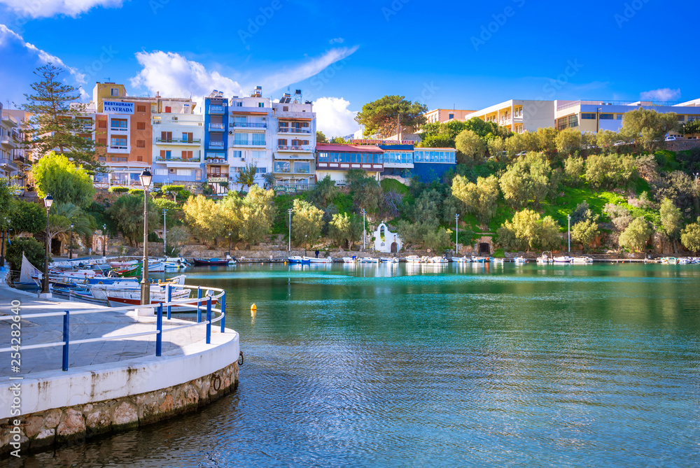 The lake Voulismeni in Agios Nikolaos,  a picturesque coastal town with colorful buildings around the port in the eastern part of the island Crete, Greece