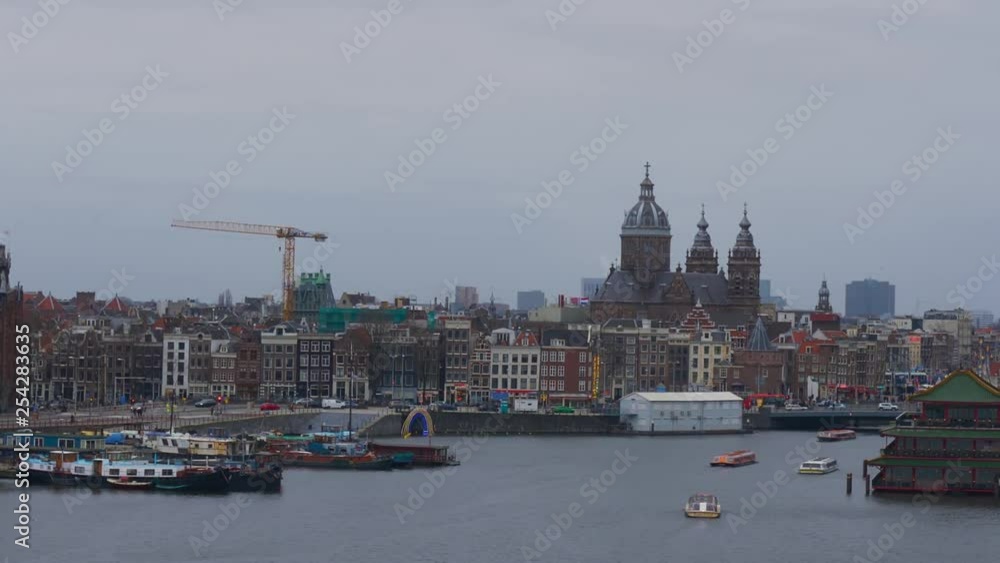 Exterior of city with channel and boats sailing. Pan right view of old city with beautiful buildings exterior and embankment with moored boats in channel Exterior of city with channel and boats sailing. Pan right view of old city with beautiful buildings exterior and embankment with moored boats in channel