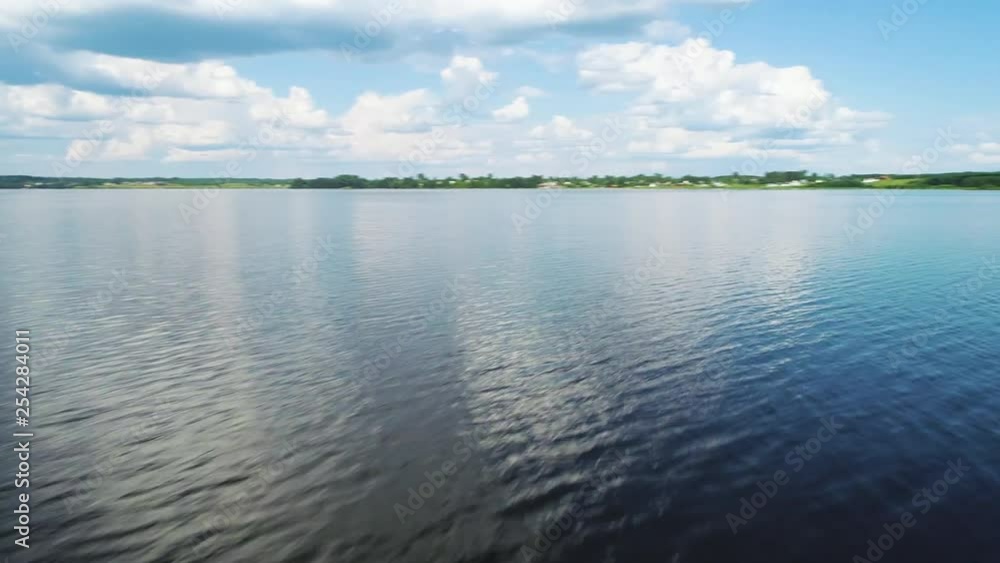 Flying over the mirror, blue smooth surface of the lake. Flying over the mirror, blue smooth surface of the lake.