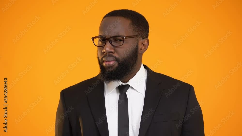 Afro-american man in suit looks suspicious police investigator finds information Afro-american man in suit looks suspicious police investigator finds information