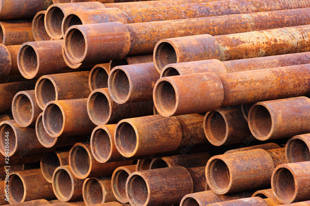 Pile of rusty metal pipes as industrial background Pile of rusty metal pipes as industrial background