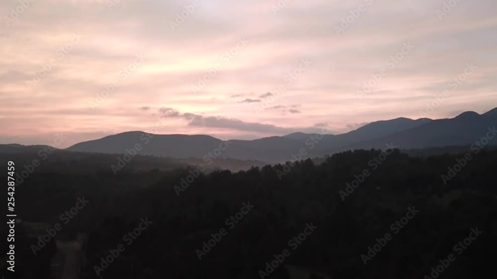 Early sunrise over Vermont mountains and evergreen trees. Early sunrise over Vermont mountains and evergreen trees.