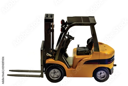 Close up view of forklift toy radiocontroled car isolated. Hobby backgrounds. 