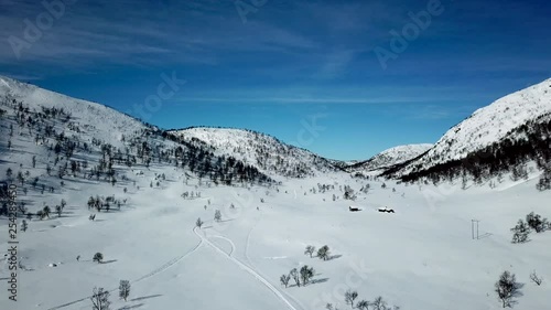 Wallpaper Mural Aerial, drone shot, over a snowy valley, between mountains, in norwegian wilderness, on a sunny, winter day, in Norway Torontodigital.ca