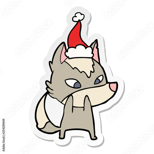 shy sticker cartoon of a wolf wearing santa hat