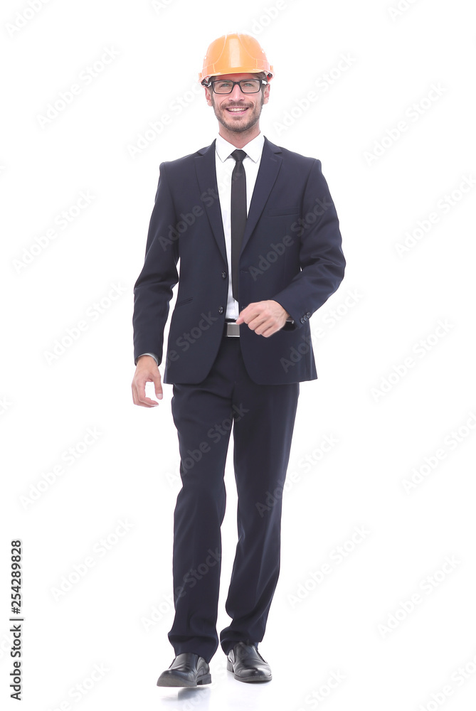 businessman in a protective helmet confidently stepping forward businessman in a protective helmet confidently stepping forward