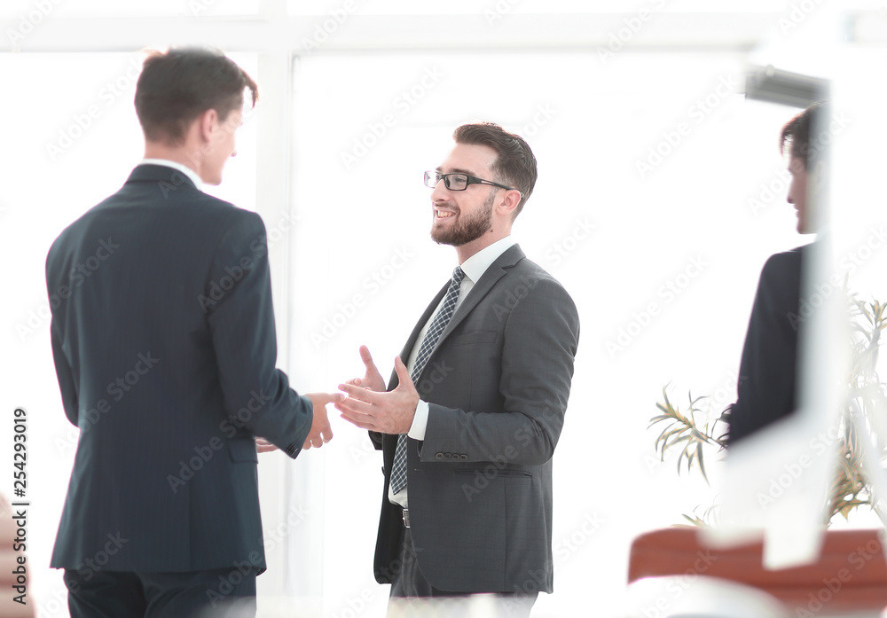 employees of the company standing in the office employees of the company standing in the office