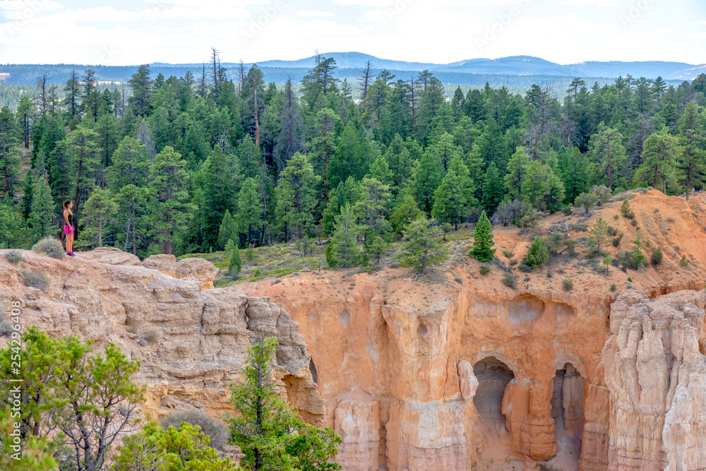 Fototapeta premium Young girl looking at Bryce Canyon Amphitheater, Utah