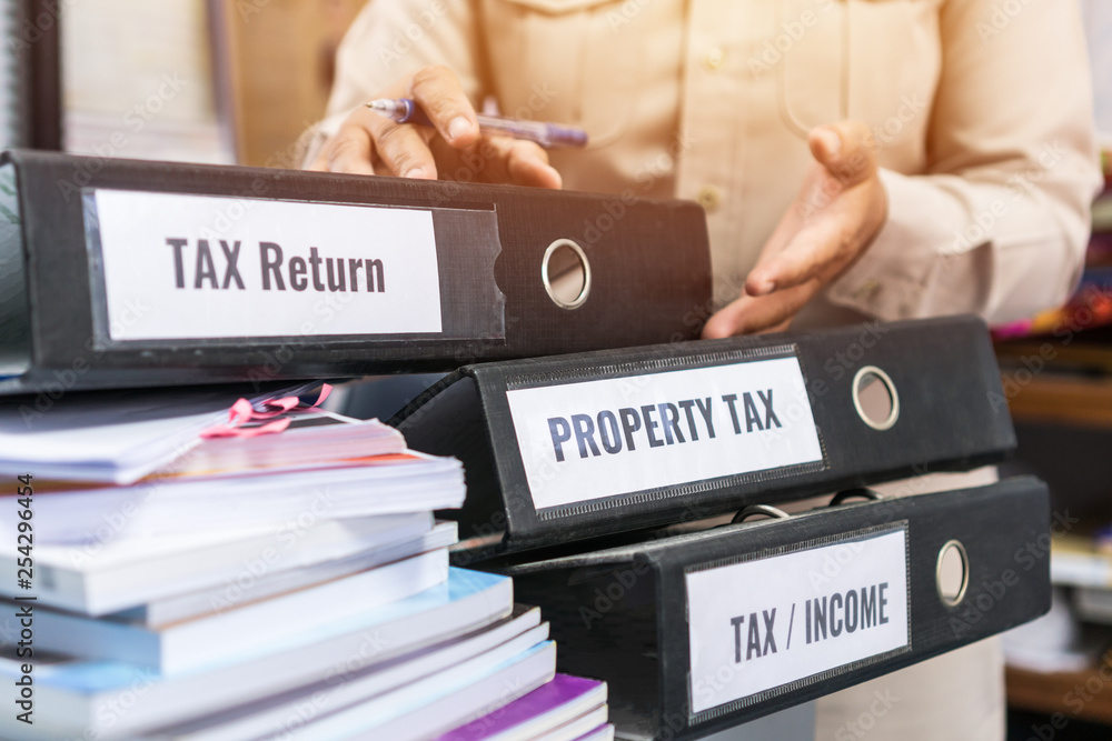 Tax return / property tax / Tax word on folders stack label