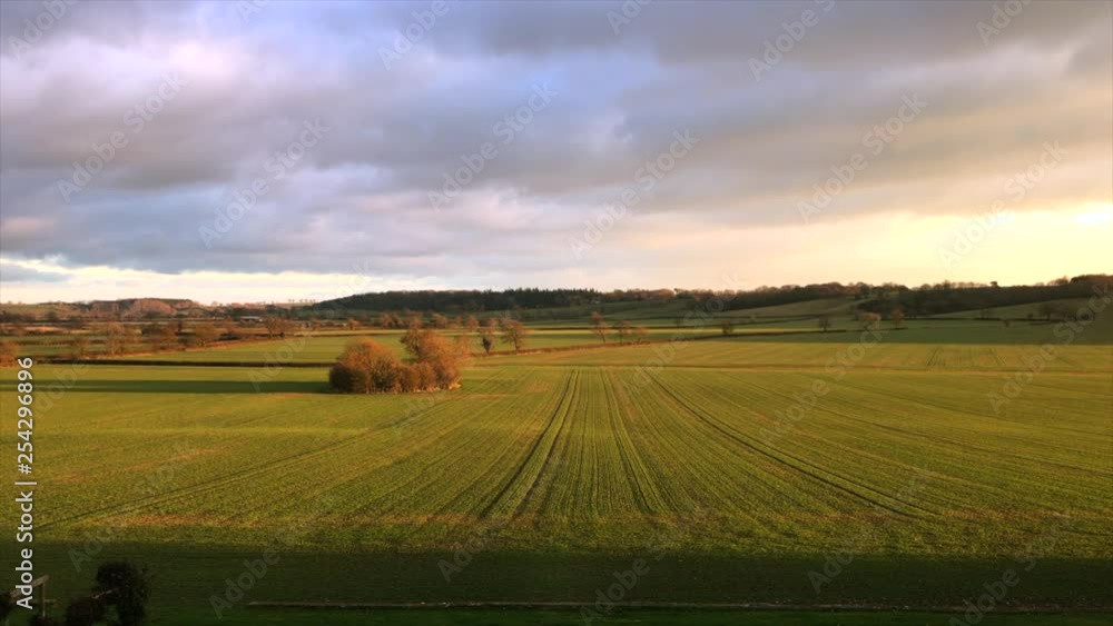 Leicestershire Manor House with Golden Skies and view over green field during day front on view