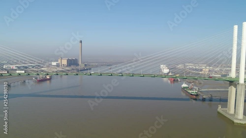 Wide aerial profile of the QE2 Dartford crossing on the River Thames, Kent / Essex England, tracking flowing traffic. photo