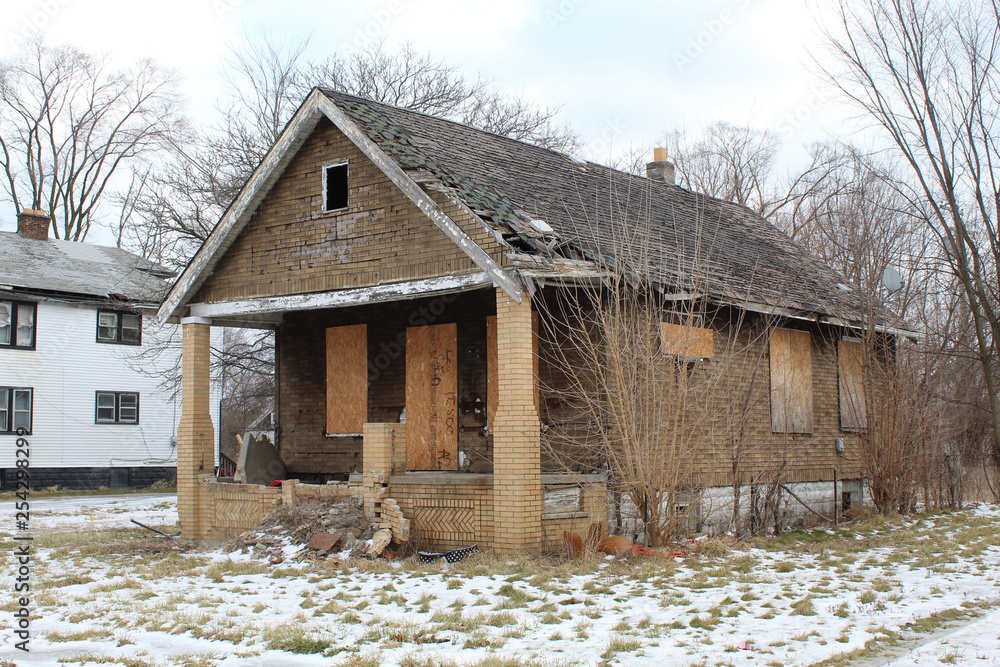 Abandoned asphalt brick home in Detroit's Hope Villlage neighborhood in winter