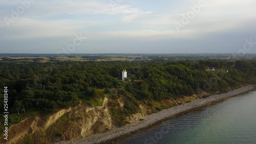 Aerial view, showing cliffs in Gilleleje, Denmark with a lighthouse on top of the cliff. photo