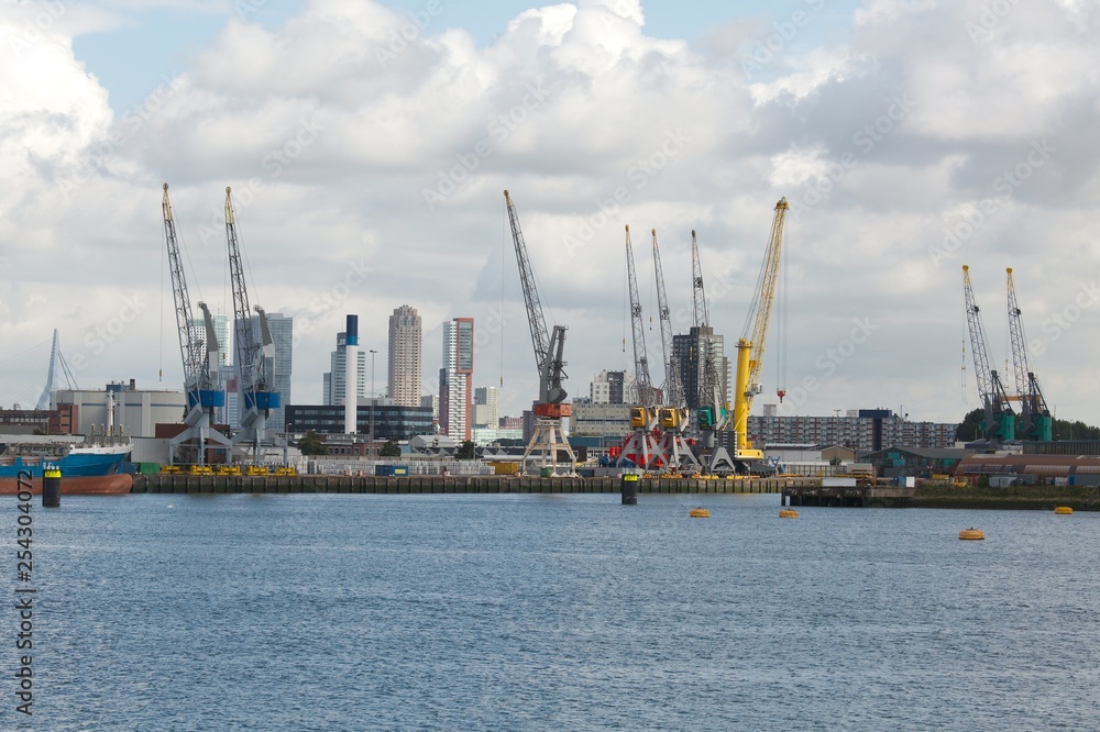 Industrial ships in dock with rotterdam city view