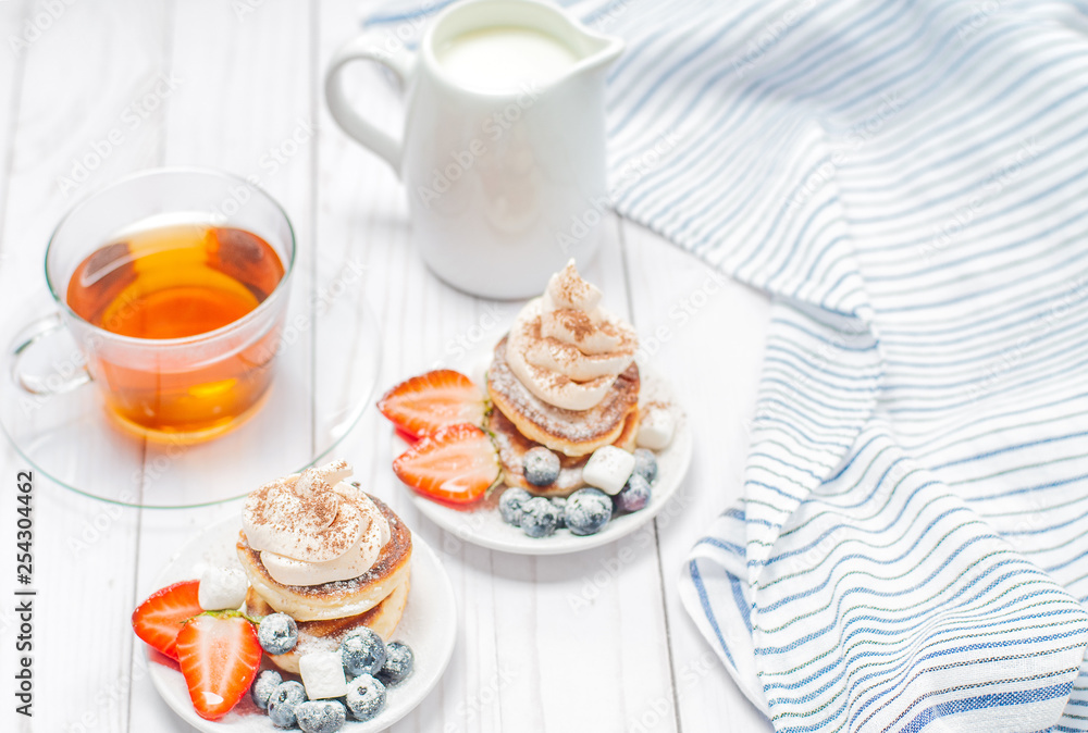 Healthy breakfast, black tea and homemade pancakes with fresh berries Healthy breakfast, black tea and homemade pancakes with fresh berries