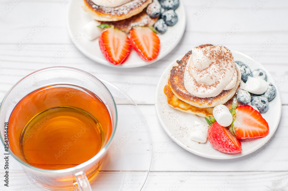 Healthy breakfast, black tea and homemade pancakes with fresh berries Healthy breakfast, black tea and homemade pancakes with fresh berries