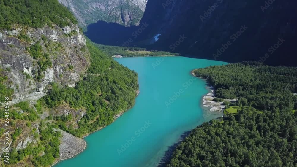 Drone shot panning up glacier water green water and glacier in the end of the valley. beautiful green water in a valley, summertime norway. Drone shot panning up glacier water green water and glacier in the end of the valley. beautiful green water in a valley, summertime norway.