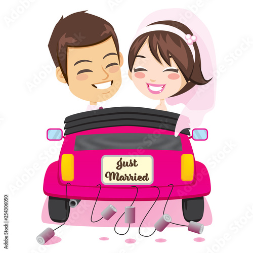 Back view of happy just married couple riding on pink car with cans attached enjoying wedding day