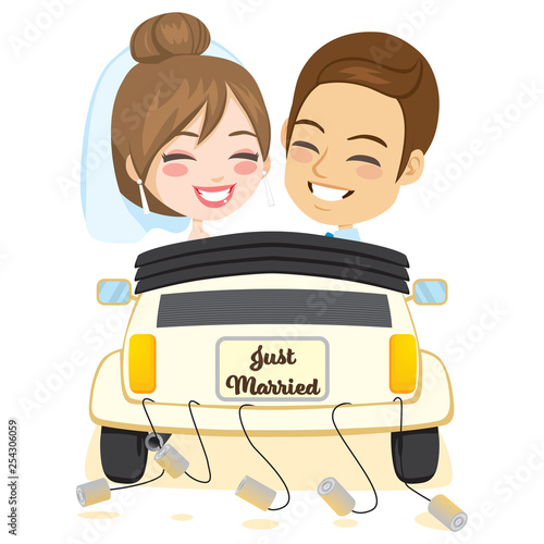 Newlywed smiling groom and bride couple driving retro car rear view
