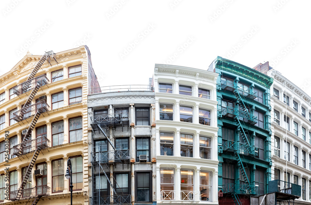 Block of colorful old historic buildings in the SoHo neighborhood in New York City isolated on empty white sky background