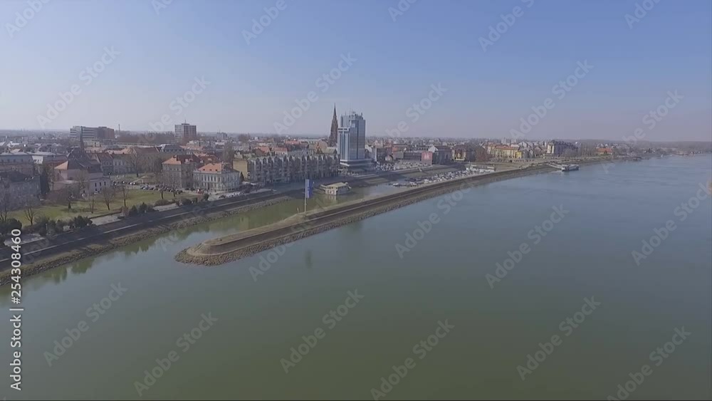 slow drone flight over river, raising up to reveal a city of Osijek Croatia slow drone flight over river, raising up to reveal a city of Osijek Croatia