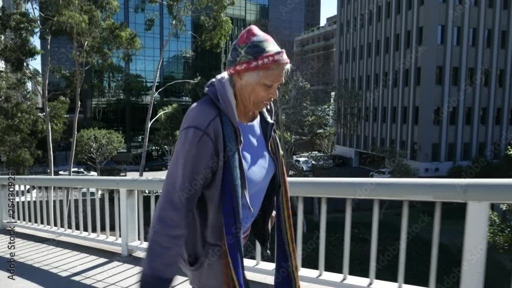 Homeless African American woman walks downtown. Homeless African American woman walks downtown.