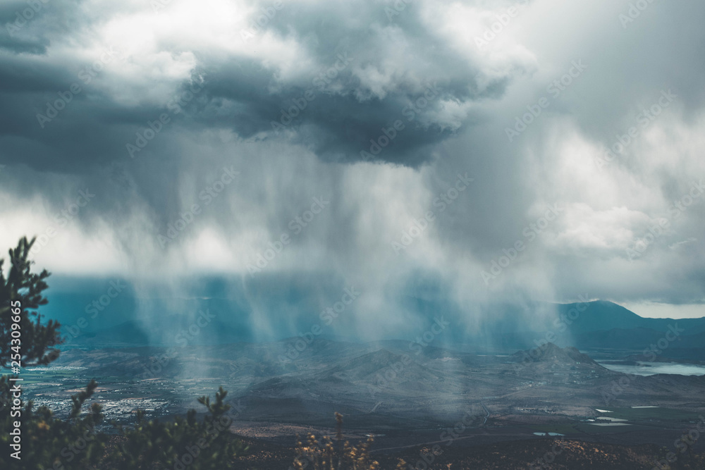Fototapeta premium Watching the rain in the city from the mountain