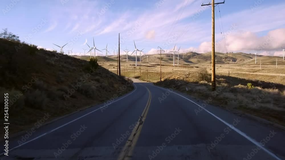 California Wind Turbines around Tehachapi in late winter with some snow on the ground. Multiple wind turbines, large and small, some not working amid a forest of power lines and grids. California Wind Turbines around Tehachapi in late winter with some snow on the ground. Multiple wind turbines, large and small, some not working amid a forest of power lines and grids.