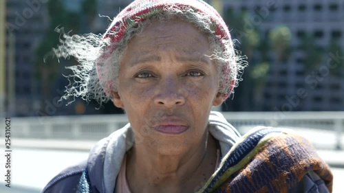 Portrait of an elderly African American homeless woman on the street.
