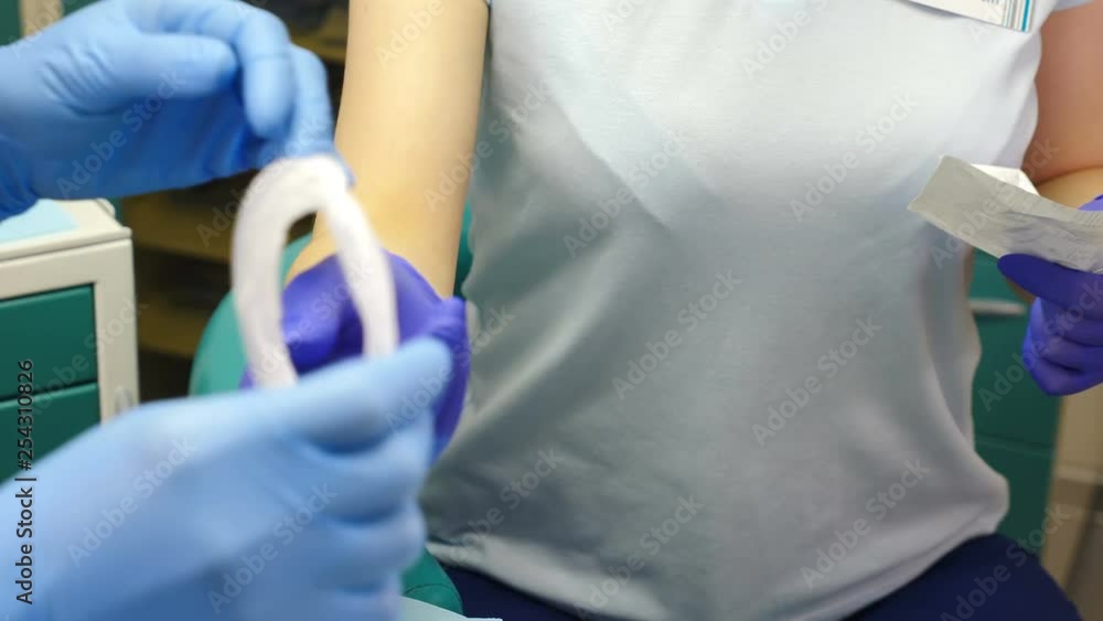 Tooth treatment. Closeup shot of female dentist assistant in gloves opening package with sterile mouth expander. Preparation for medical examination. dentist in his office prepares expander for mouth Tooth treatment. Closeup shot of female dentist assistant in gloves opening package with sterile mouth expander. Preparation for medical examination. dentist in his office prepares expander for mouth