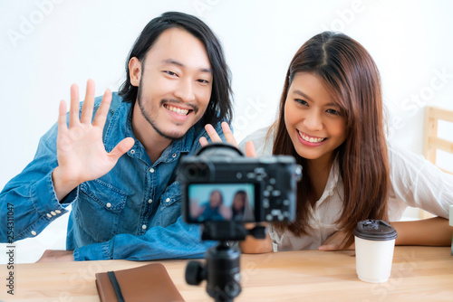 asian couple blogger enjoy communication lives with camera house background concept photo