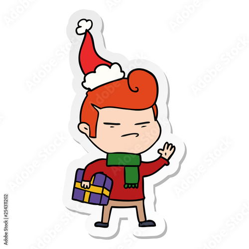 sticker cartoon of a cool guy with fashion hair cut wearing santa hat
