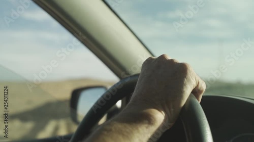 Wallpaper Mural CU of man's hand on steering wheel in desert Torontodigital.ca