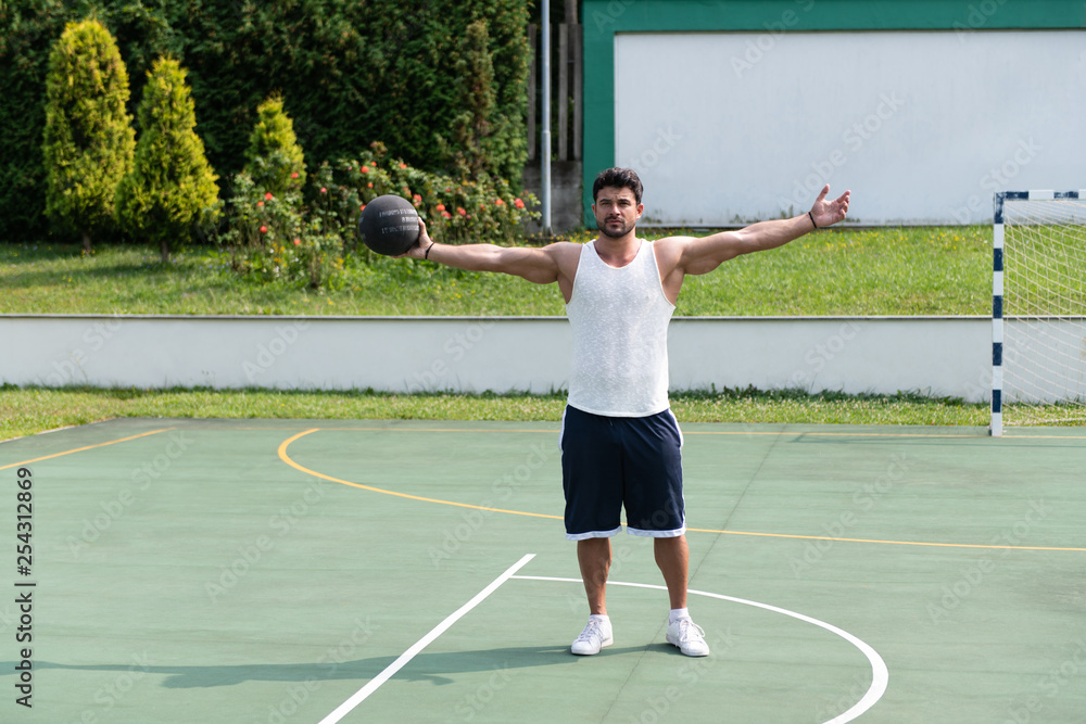 Bodybuilder Playing Basketball Outdoor