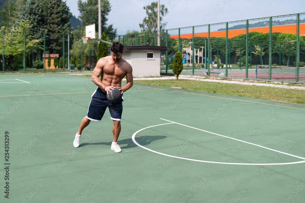 Bodybuilder Playing Basketball Outdoor
