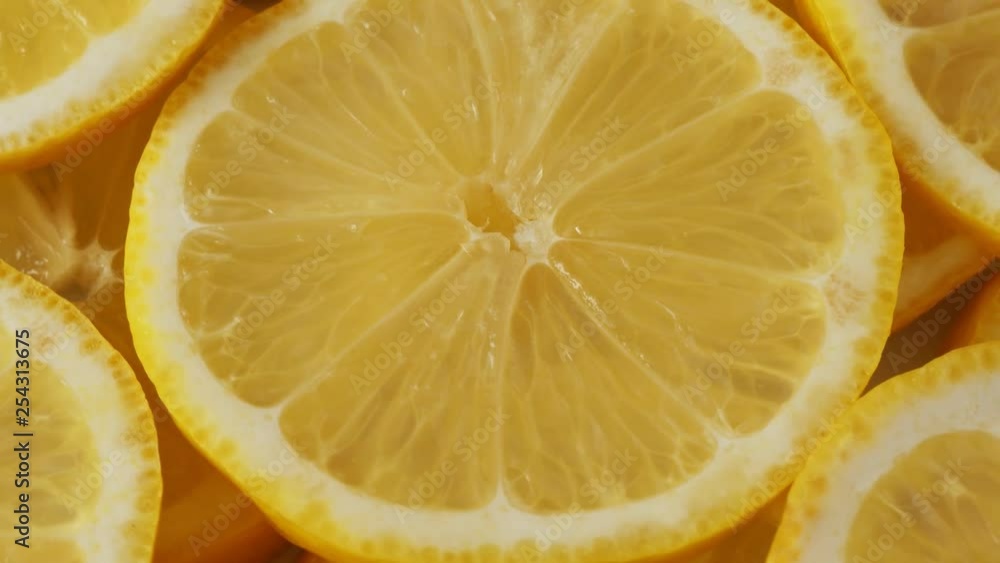 Lemon slices closeup, food summer background, fruits top view. Rotate Lemon slices closeup, food summer background, fruits top view. Rotate