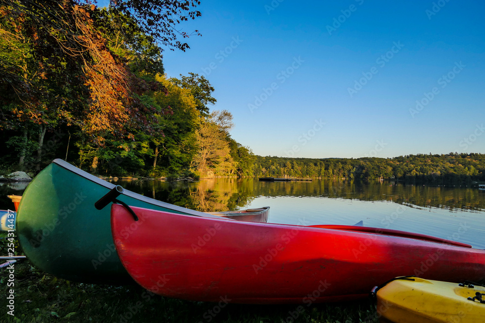Fototapeta premium WEST CORNWALL CT USA Canoes on Cream Hill Lake in New England, colors, fall, autumn, landscape